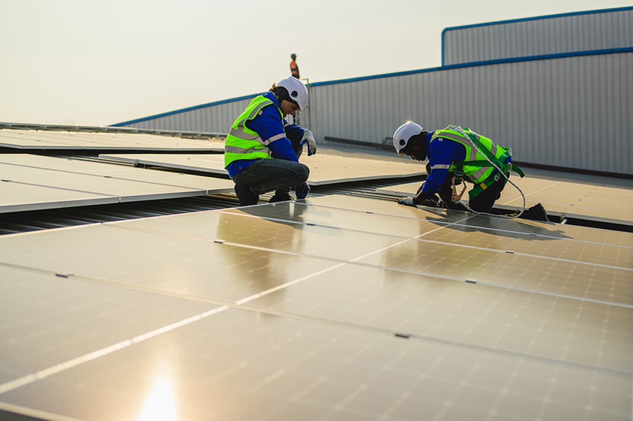 Two solar technicians doing a commercial installation
