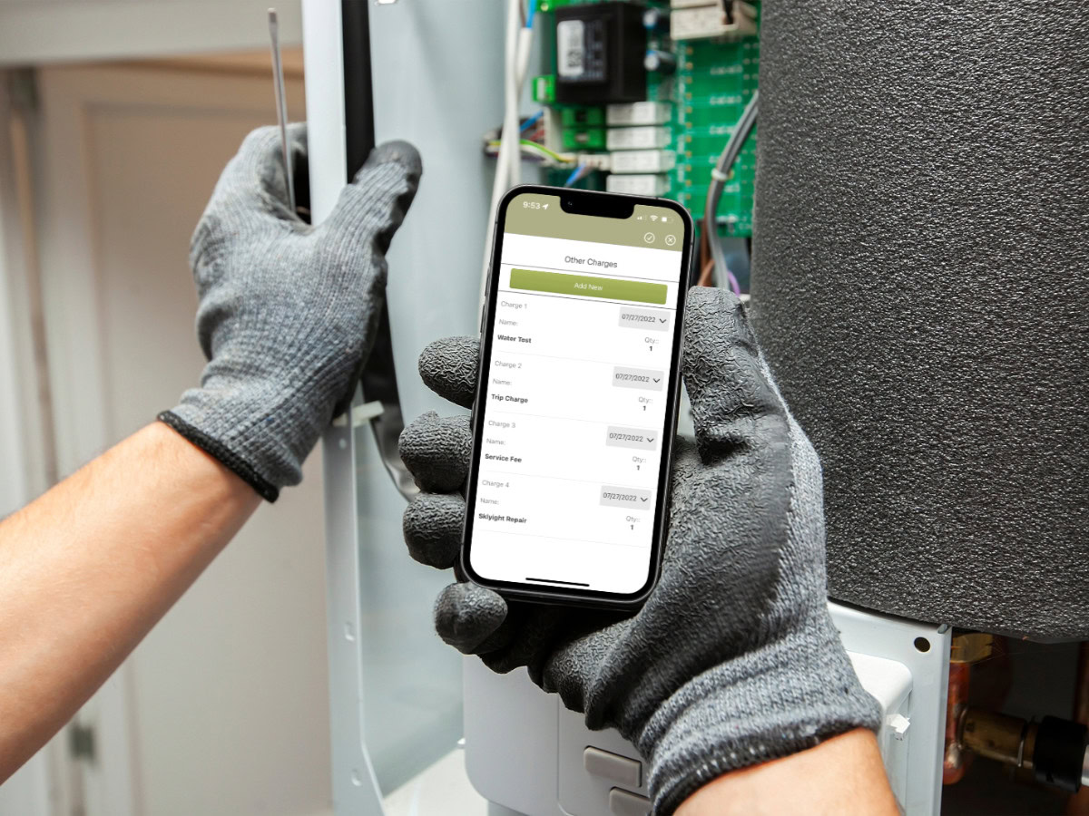 Gloved hand holding up a mobile device and viewing a field service management software