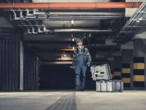 A plumber checking commercial plumbing pipes.